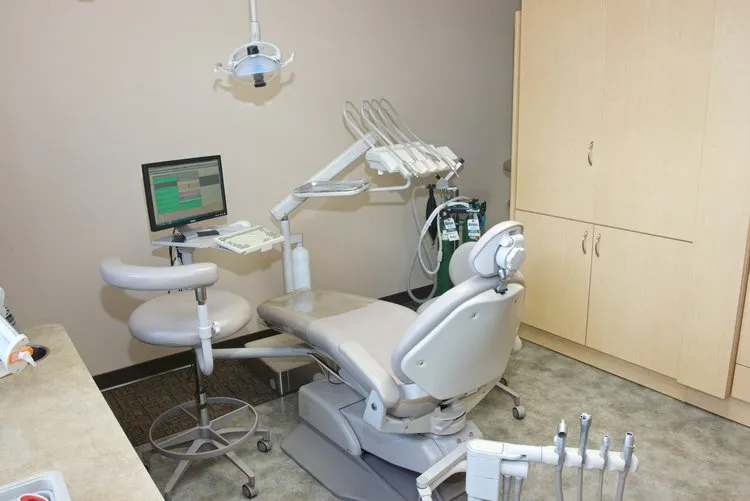 Right view of procedure room Office Photo with chair, dental technology, and cabinets