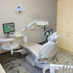 Right view of procedure room Office Photo with chair, dental technology, and cabinets