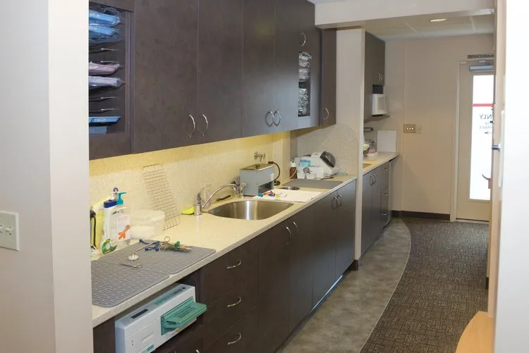 Office Photo of hallway with cabinets and hand washing station