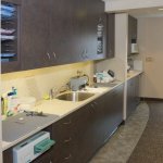 Office Photo of hallway with cabinets and hand washing station